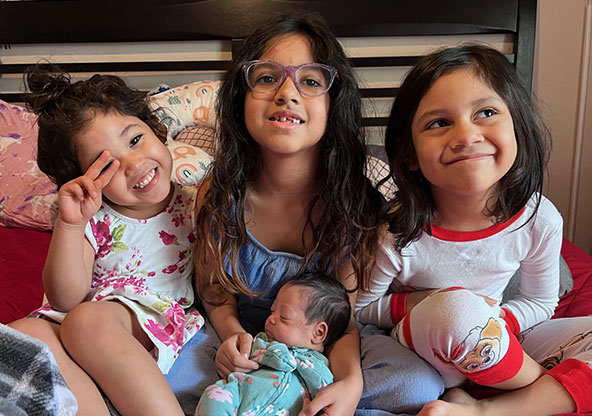 The Collins girls holding baby Hosanna, their new sister.