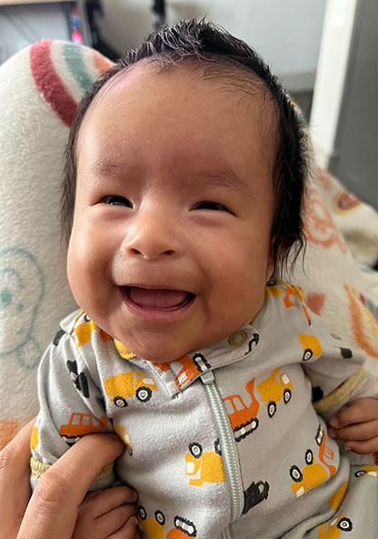 John Ezekiel Mendez, Jr. smiles at the camera 