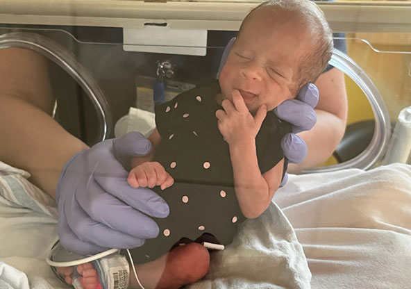 Meadow smiling in NICU