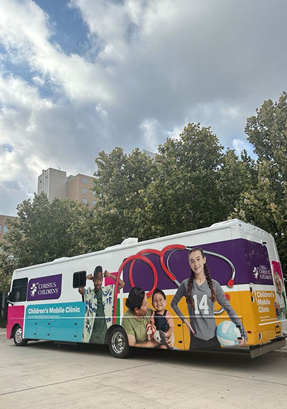 CHRISTUS Children's Mobile Clinic bus is wrapped with images of children