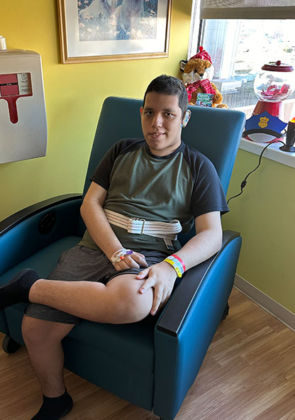 Samuel Trejo sits in a chair in his room at CHRISTUS Children's