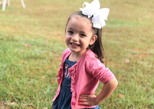 Kimber with her hand on her hip posing and smiling for the camera.