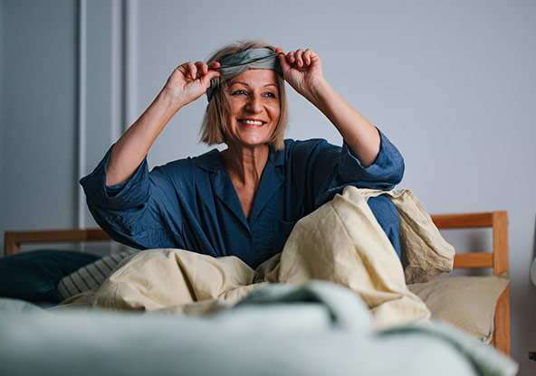 A middle-aged woman waking up from a refreshing sleep
